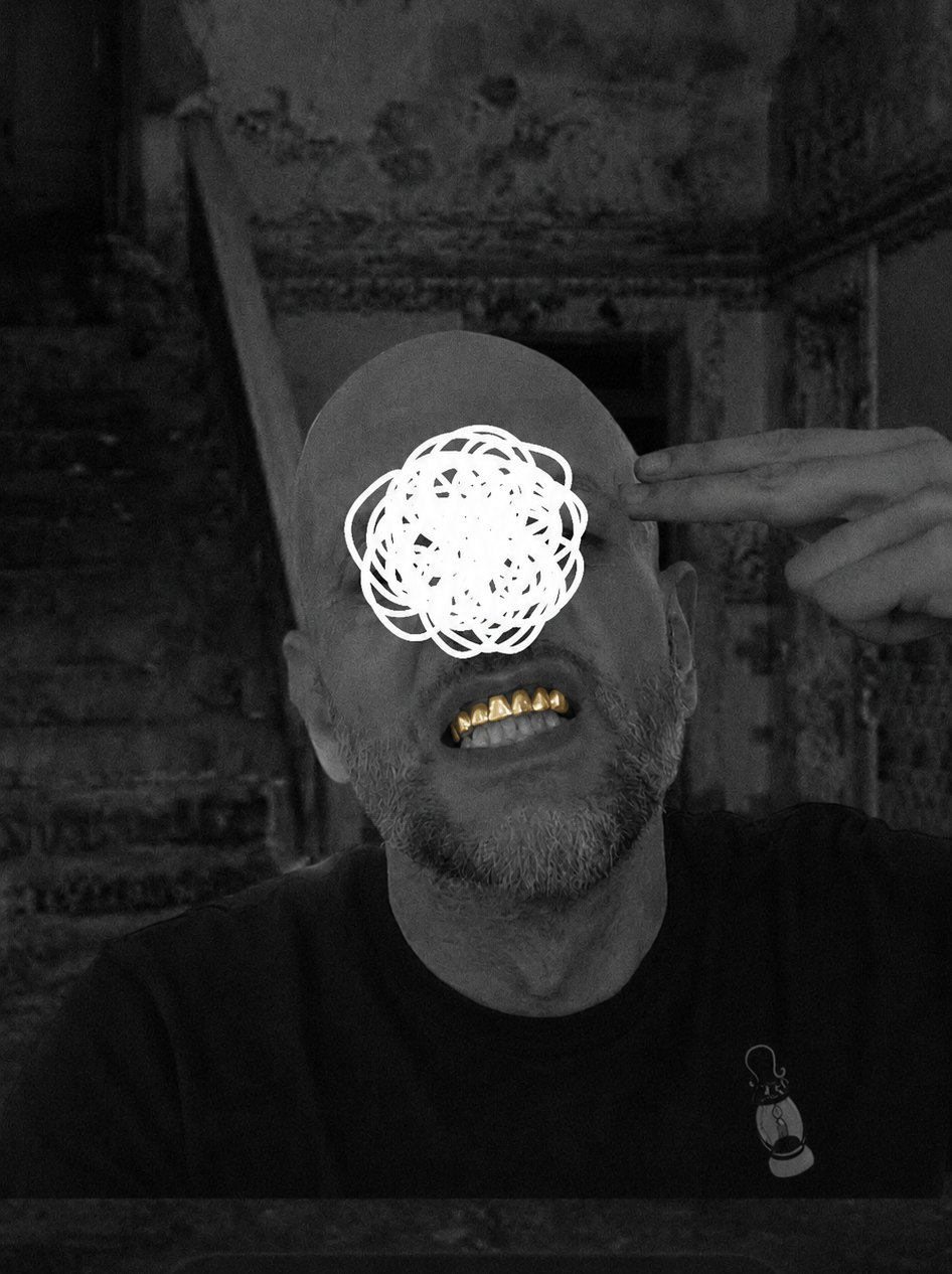 James Balmond in black and white, a scribbled white swirl over his eyes and gold teeth